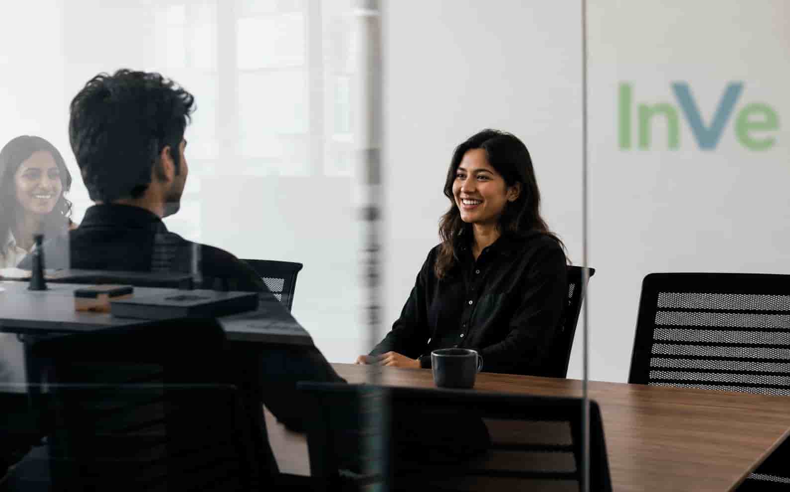 InVenire colleagues in conversation in a meeting room.